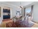 Bright dining room features a modern chandelier, large windows, and a convenient dry bar at 1002 Detroit St, Denver, CO 80206