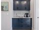 Modern dry bar with sleek navy cabinetry, stylish tile backsplash, and premium countertops at 1002 Detroit St, Denver, CO 80206