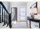 Inviting entryway with sleek black accents, light wood floors, and a modern aesthetic at 1002 Detroit St, Denver, CO 80206