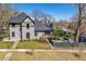 Charming two-story home boasts beautiful curb appeal and a well-manicured front yard with mature landscaping at 1002 Detroit St, Denver, CO 80206