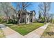 This charming home features a well-manicured lawn, mature trees, and inviting curb appeal at 1002 Detroit St, Denver, CO 80206