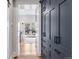 Hallway with hardwood floors and custom cabinetry leads to a bright kitchen with backyard access at 1002 Detroit St, Denver, CO 80206
