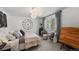 Light-filled bedroom featuring a cozy bed, modern light fixture, and a large window at 1935 Poncha Ct, Larkspur, CO 80118