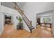 Welcoming foyer featuring hardwood floors, a staircase, and natural light at 1935 Poncha Ct, Larkspur, CO 80118