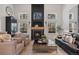 Cozy living room showcasing a fireplace, a large window, and hardwood floors at 1935 Poncha Ct, Larkspur, CO 80118
