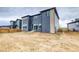 View of the gray home and backyard, including a wooden fence, in a suburban neighborhood at 23708 E 42Nd Ave, Aurora, CO 80019