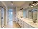 Luxurious bathroom featuring double sinks, a glass-enclosed shower, and modern fixtures at 23708 E 42Nd Ave, Aurora, CO 80019