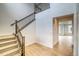Elegant foyer featuring a staircase with wooden railing and light hardwood floors at 23708 E 42Nd Ave, Aurora, CO 80019