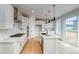 Modern kitchen featuring stainless steel appliances, white cabinets, and a large center island at 23708 E 42Nd Ave, Aurora, CO 80019