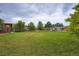 Extensive backyard showcases a vast lawn, landscaping, and the rear facade of the home at 8455 W Belmar Ave, Lakewood, CO 80226