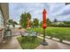 Inviting backyard with lush green lawn, patio, stylish seating area, and mature trees at 8455 W Belmar Ave, Lakewood, CO 80226
