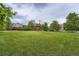 Large backyard features a lush lawn, mature trees, and a charming shed, ideal for outdoor enjoyment at 8455 W Belmar Ave, Lakewood, CO 80226