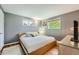 Cozy bedroom with natural light, hardwood floors, neutral paint, and a comfortable queen-sized bed at 8455 W Belmar Ave, Lakewood, CO 80226