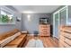 Comfortable bedroom with a sitting area, natural light, hardwood floors, neutral paint, and updated furniture at 8455 W Belmar Ave, Lakewood, CO 80226