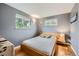 Comfortable bedroom with natural light, hardwood floors, neutral paint, and a comfortable queen-sized bed at 8455 W Belmar Ave, Lakewood, CO 80226