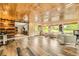 Bonus room showing tile flooring, wood ceiling, multiple windows, and open access to other parts of the house at 8455 W Belmar Ave, Lakewood, CO 80226