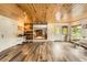 Bonus room featuring tile flooring, wood ceiling, multiple windows, and a barn door to the living room at 8455 W Belmar Ave, Lakewood, CO 80226