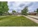 Charming single-story home with a well-manicured lawn, beautiful landscaping, and a welcoming entrance at 8455 W Belmar Ave, Lakewood, CO 80226