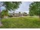 Charming single-story home with a well-manicured lawn, beautiful landscaping, and a welcoming entrance at 8455 W Belmar Ave, Lakewood, CO 80226