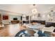 Open-concept kitchen and living room featuring modern appliances, stylish decor, and hardwood floors at 8455 W Belmar Ave, Lakewood, CO 80226