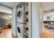 Functional laundry area includes a stacked washer and dryer, with built-in shelving for storage at 8455 W Belmar Ave, Lakewood, CO 80226