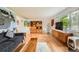 Bright living room featuring hardwood floors, large windows, and curated eclectic decor and a comfortable seating area at 8455 W Belmar Ave, Lakewood, CO 80226