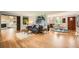 Open living room featuring hardwood floors, modern decor, and seamless flow to the kitchen at 8455 W Belmar Ave, Lakewood, CO 80226