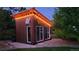 Charming wooden studio illuminated with string lights, nestled amongst lush greenery at 8455 W Belmar Ave, Lakewood, CO 80226