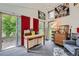 Bright studio interior with modern decor, a desk, artwork, and large windows overlooking a green lawn at 8455 W Belmar Ave, Lakewood, CO 80226