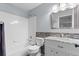 Bathroom with a shower-tub combo, mosaic tile, and single vanity sink at 7411 S Crescent Ct, Littleton, CO 80120