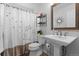 Bathroom with floral curtain and white pedestal sink at 7411 S Crescent Ct, Littleton, CO 80120