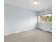 This bedroom features a light gray carpet and pale blue walls at 7411 S Crescent Ct, Littleton, CO 80120