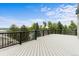 Spacious deck with black railings offering stunning views of the surrounding landscape at 7411 S Crescent Ct, Littleton, CO 80120