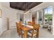 Dining room with modern lighting, large window, and wooden table with seating for six at 7411 S Crescent Ct, Littleton, CO 80120