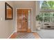 Home foyer features a hardwood floor, high ceilings, large front door, and contemporary decorations at 7411 S Crescent Ct, Littleton, CO 80120