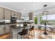 Well-equipped kitchen features granite countertops, stainless appliances, island seating, and a breakfast nook at 7411 S Crescent Ct, Littleton, CO 80120
