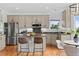 Spacious kitchen offers stainless steel appliances, granite countertops, a center island, and breakfast area at 7411 S Crescent Ct, Littleton, CO 80120