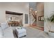 Comfortable living area offers seamless transition to dining room with staircase and large windows at 7411 S Crescent Ct, Littleton, CO 80120