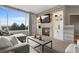 Comfortable living room with fireplace, modern decor, large window with great backyard views at 7411 S Crescent Ct, Littleton, CO 80120