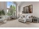 Living room with vaulted ceilings, large windows, comfortable seating, and tasteful decor at 7411 S Crescent Ct, Littleton, CO 80120