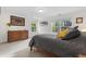 Primary bedroom with wood accents, soft lighting, and two large windows at 7411 S Crescent Ct, Littleton, CO 80120