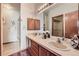 Functional bathroom features double sinks, vanity mirror, wood cabinets, and a separate shower area at 2288 S Depew St, Lakewood, CO 80227