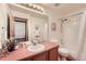 Functional bathroom with double sinks, a large mirror, a bathtub/shower combo, and plenty of storage at 2288 S Depew St, Lakewood, CO 80227