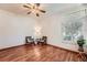 Comfortable bedroom with hardwood floors, ceiling fan, shutters and sun-filled window at 2288 S Depew St, Lakewood, CO 80227