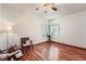 Simple and comfortable bedroom featuring hardwood floors, ceiling fan, and ample natural light at 2288 S Depew St, Lakewood, CO 80227