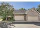 Attached two-car garage with brick and siding exterior, showcasing curb appeal and functionality at 2288 S Depew St, Lakewood, CO 80227