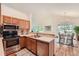 Modern kitchen featuring stainless steel appliances and a view of the dining area at 2288 S Depew St, Lakewood, CO 80227