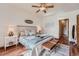 Cozy main bedroom with ceiling fan, stylish decor, and convenient access to the ensuite bathroom at 2288 S Depew St, Lakewood, CO 80227