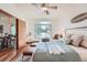 Inviting main bedroom boasts a ceiling fan, large window, and seamless flow into the adjacent dining area at 2288 S Depew St, Lakewood, CO 80227