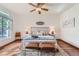 Cozy main bedroom featuring a ceiling fan, neutral decor, and large window for natural light at 2288 S Depew St, Lakewood, CO 80227